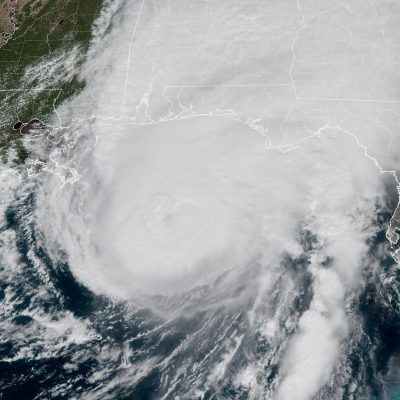 ‘The storm is here – buckle down’: Hurricane Isaias makes landfall in US